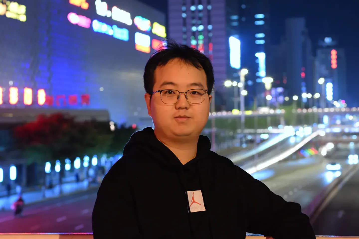 夜间城市灯光和道路背景前的本人半身照